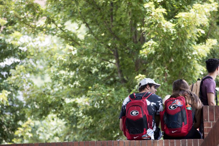 Students walking outside with UGA backpacks on